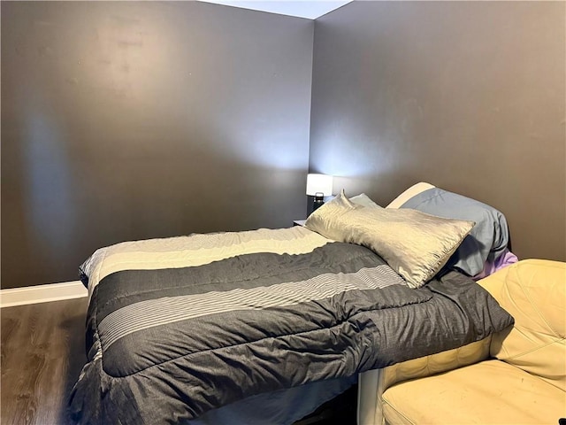 bedroom featuring dark hardwood / wood-style flooring