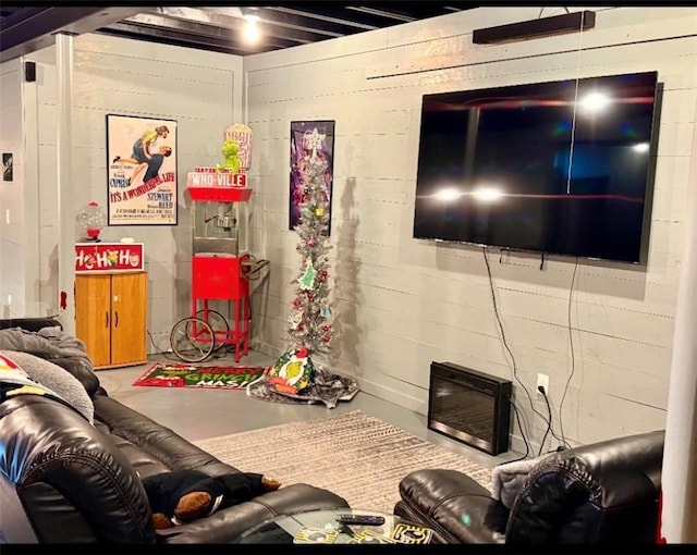 living room with concrete flooring and a fireplace