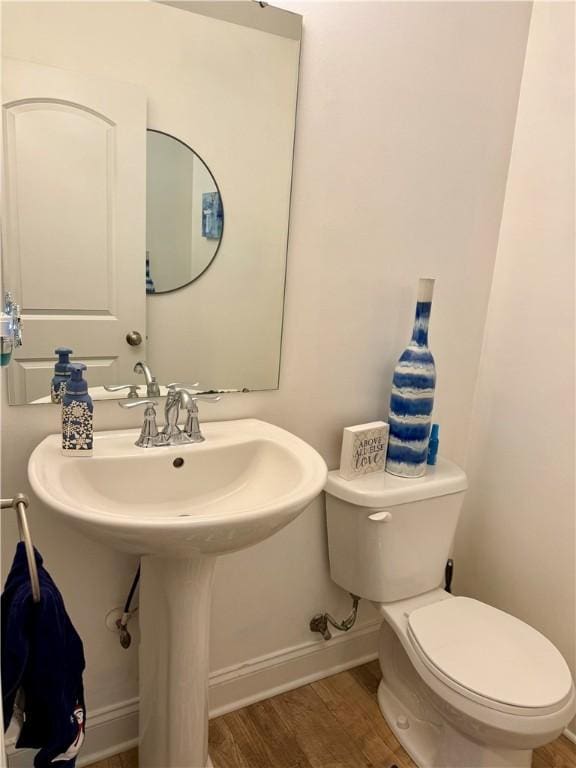 bathroom featuring toilet and wood-type flooring