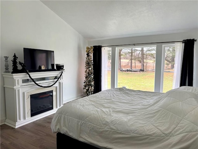 bedroom featuring dark hardwood / wood-style floors and lofted ceiling