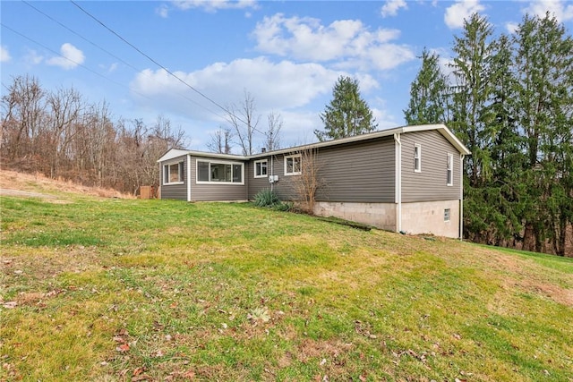 rear view of property featuring a lawn