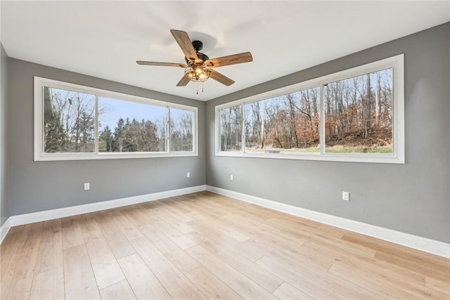 spare room featuring ceiling fan and light wood-type flooring