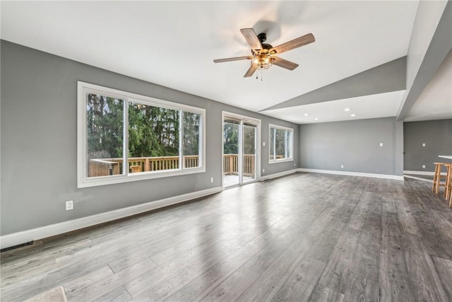 unfurnished living room with ceiling fan, light hardwood / wood-style flooring, and lofted ceiling