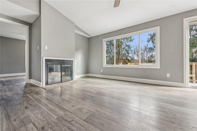 unfurnished living room with hardwood / wood-style floors, ceiling fan, and lofted ceiling