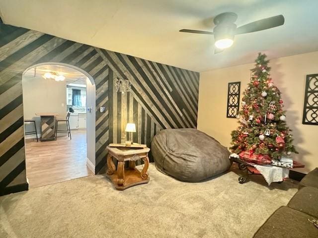 living area with hardwood / wood-style flooring and ceiling fan