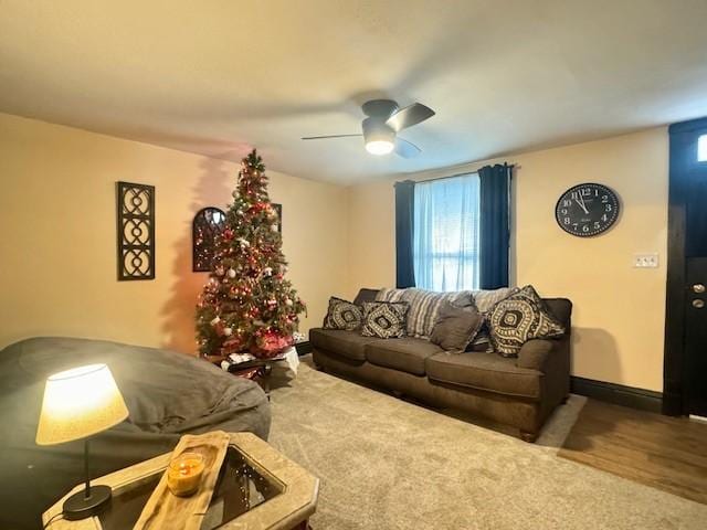 living room featuring ceiling fan and carpet floors