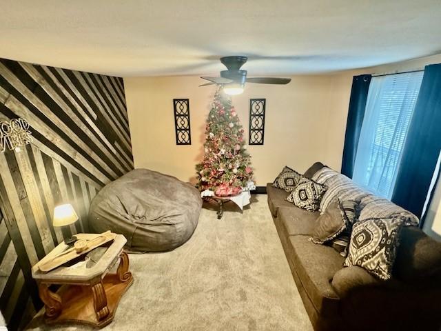 living room with carpet flooring and ceiling fan