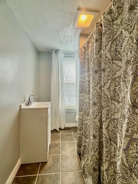 bathroom featuring tile patterned flooring, vanity, and toilet