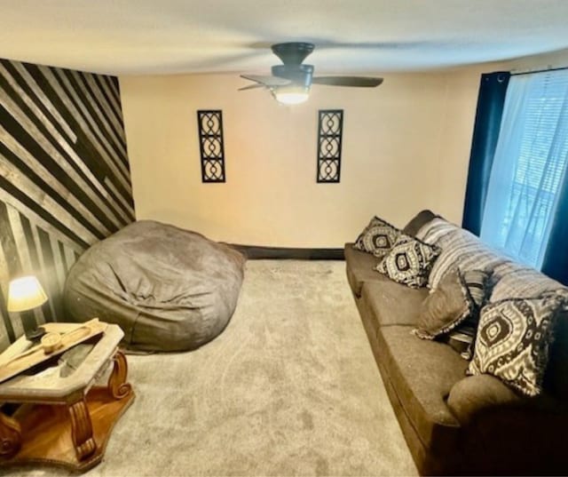 carpeted living room with ceiling fan