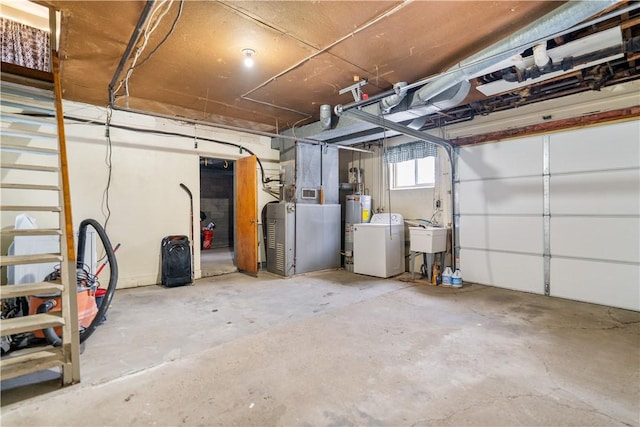 garage featuring washer / dryer, water heater, and sink