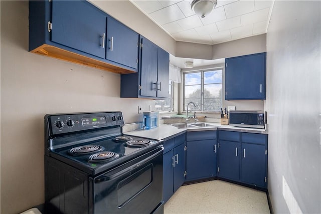 kitchen featuring blue cabinetry, black / electric stove, and sink