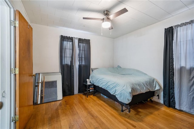 bedroom with ceiling fan and hardwood / wood-style flooring