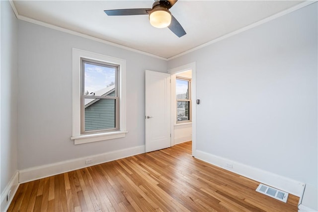 unfurnished room featuring ceiling fan, ornamental molding, and light wood-type flooring