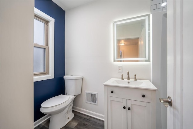 bathroom with vanity, hardwood / wood-style flooring, and toilet