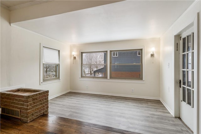 spare room featuring hardwood / wood-style flooring and ornamental molding