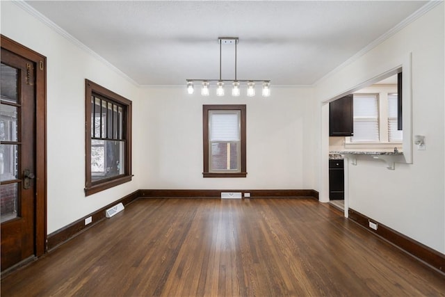 unfurnished dining area with crown molding and dark wood-type flooring