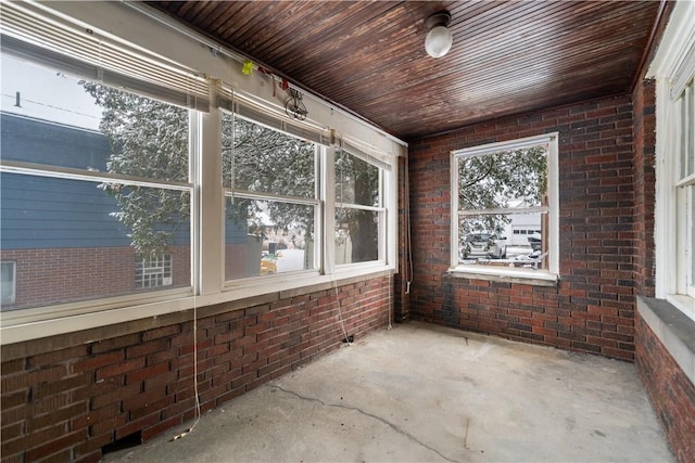 unfurnished sunroom with wooden ceiling