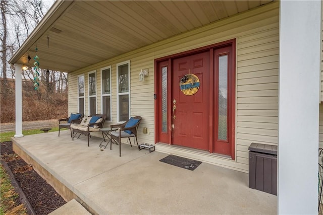 view of exterior entry with a porch