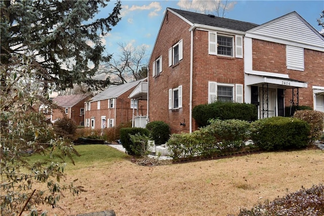 view of side of home with a yard