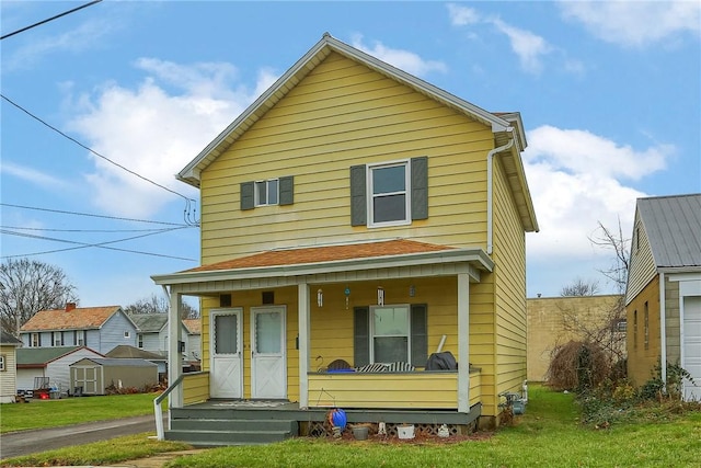 view of front of house with a porch and a front yard