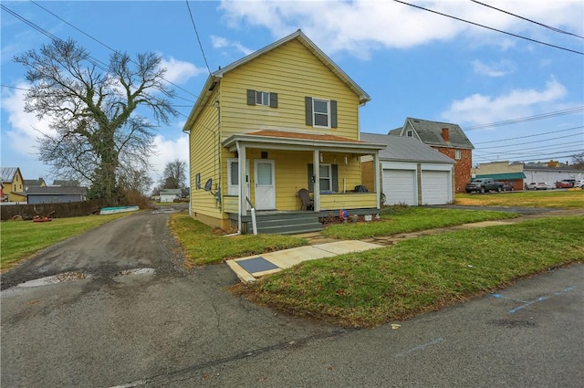 view of front of property with a porch, a garage, and a front lawn