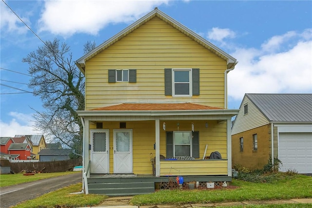 view of property with a porch and a garage