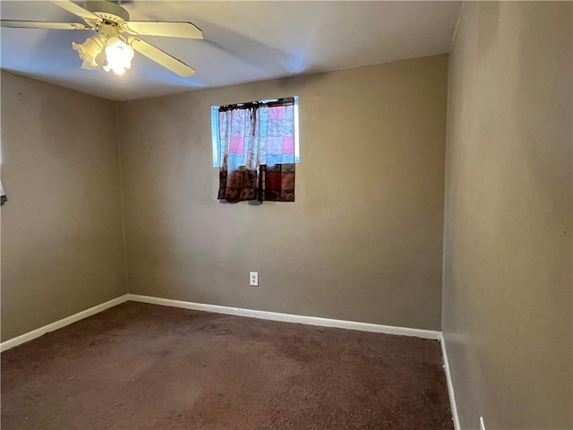 empty room featuring ceiling fan and dark colored carpet