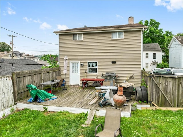 rear view of house with a wooden deck