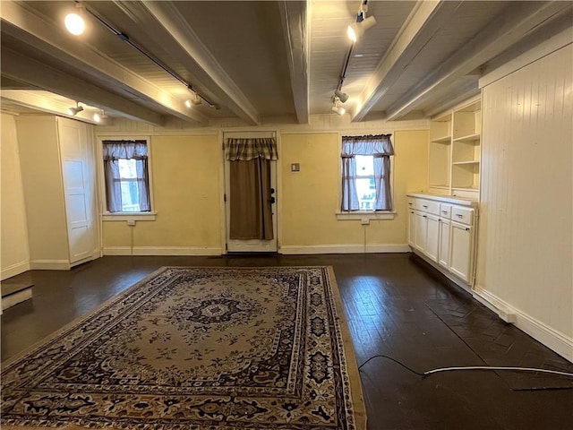 interior space with rail lighting and dark hardwood / wood-style floors