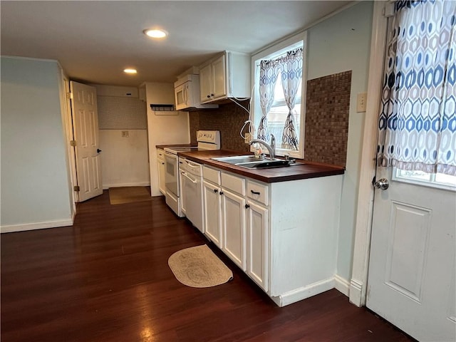 kitchen featuring white electric range oven, dark hardwood / wood-style flooring, decorative backsplash, and sink