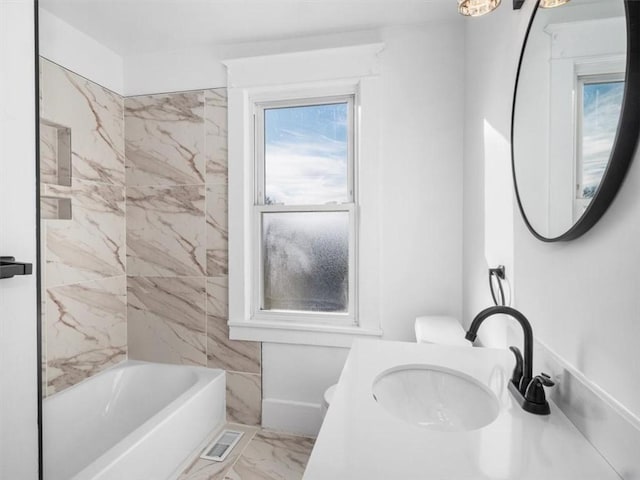 bathroom featuring sink and tiled shower / bath combo