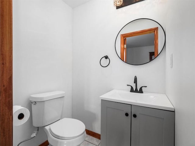 bathroom with tile patterned flooring, vanity, and toilet