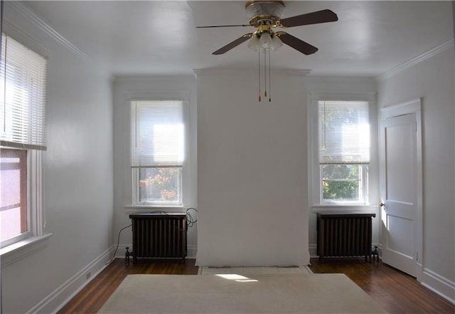 interior space featuring dark hardwood / wood-style flooring, ceiling fan, radiator heating unit, and crown molding