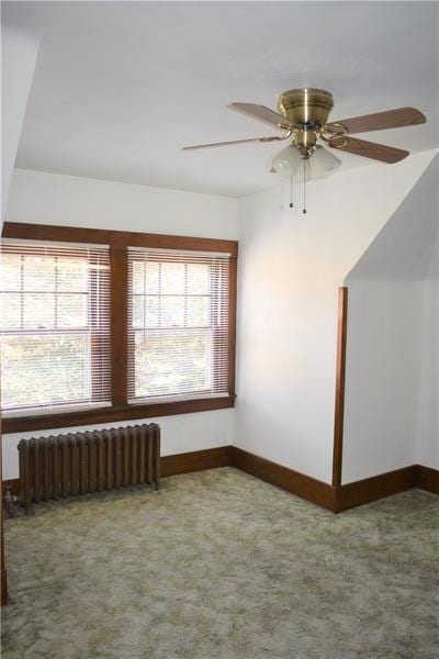 bonus room featuring carpet flooring, radiator heating unit, and ceiling fan