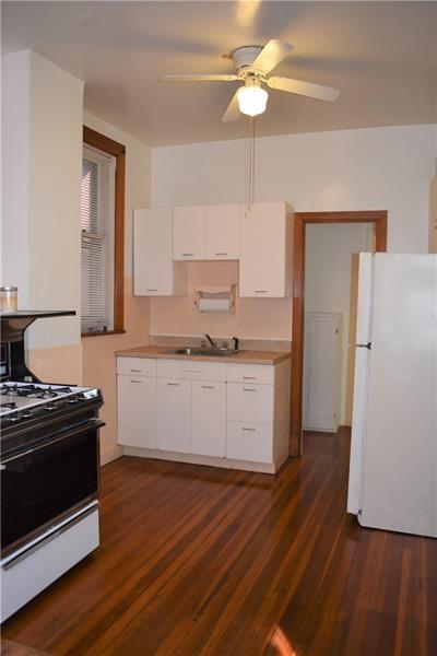 kitchen featuring white cabinets, dark hardwood / wood-style floors, ceiling fan, and white appliances