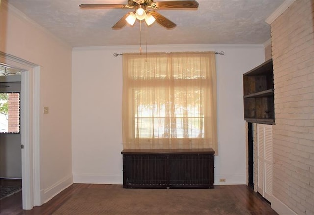 spare room with radiator, crown molding, ceiling fan, a textured ceiling, and dark hardwood / wood-style flooring