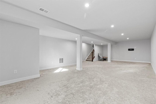 basement featuring light carpet