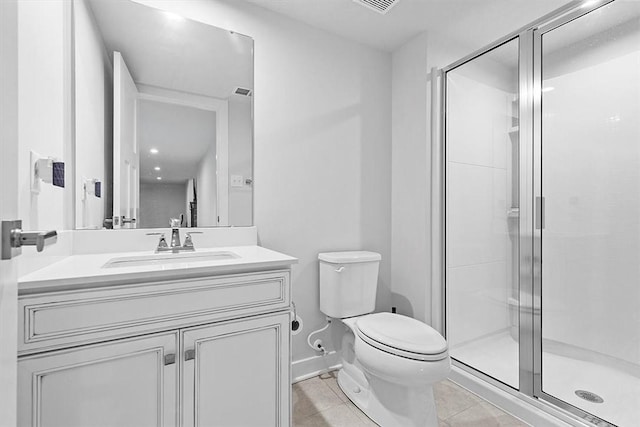 bathroom with tile patterned flooring, a shower with door, vanity, and toilet