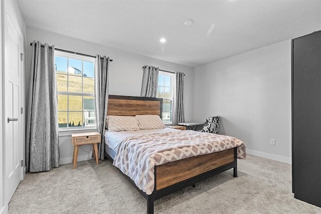 carpeted bedroom featuring multiple windows