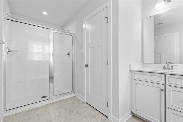 bathroom featuring vanity and an enclosed shower