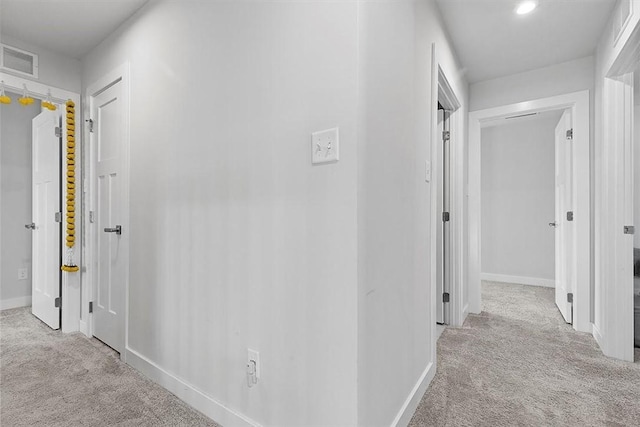 hallway with light colored carpet