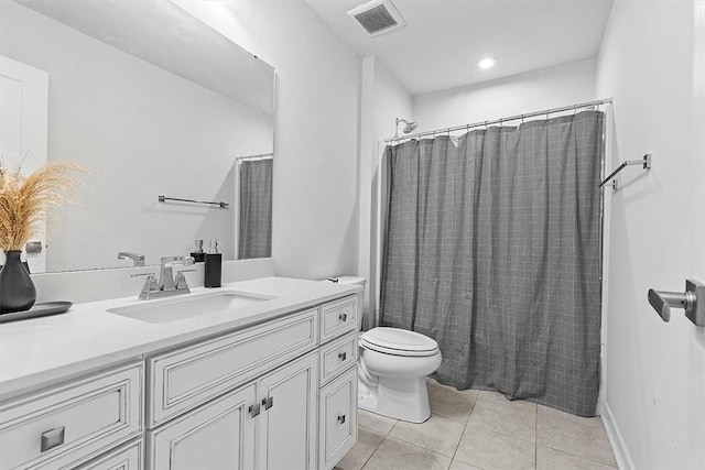 full bathroom featuring tile patterned floors, vanity, toilet, and shower / bath combo