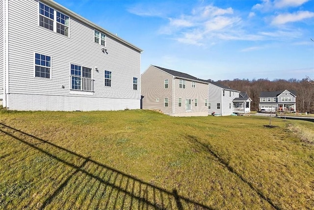 back of house featuring a lawn