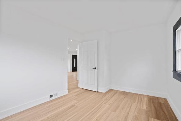 unfurnished room featuring light hardwood / wood-style flooring