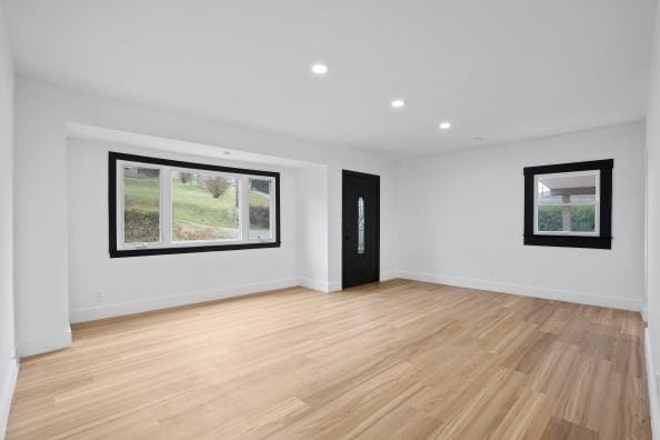 spare room with light hardwood / wood-style flooring