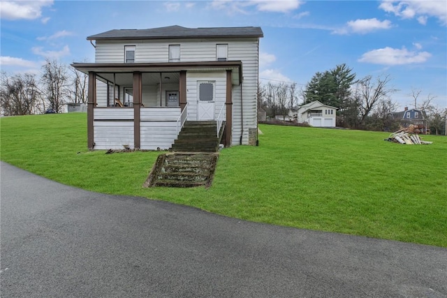 view of front of home with covered porch and a front lawn