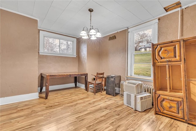 misc room featuring a wealth of natural light, ornamental molding, a notable chandelier, and light wood-type flooring