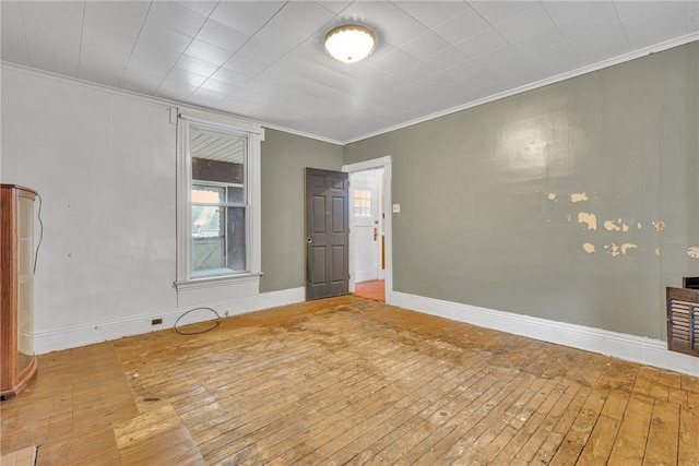 unfurnished room featuring wood-type flooring and ornamental molding