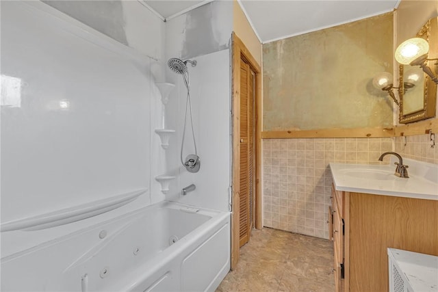 bathroom featuring vanity, tile walls, and bathtub / shower combination