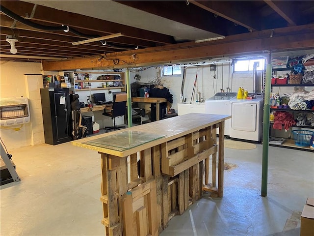 basement featuring washer and dryer and heating unit